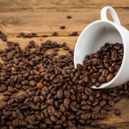 Coffee cup and coffee beans on a wooden table